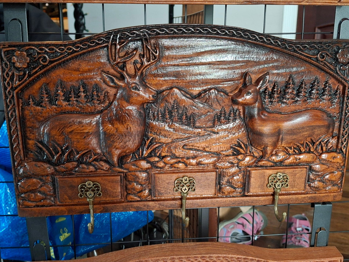 Hand-carved deer key rack with buck and doe relief carving and three brass hooks